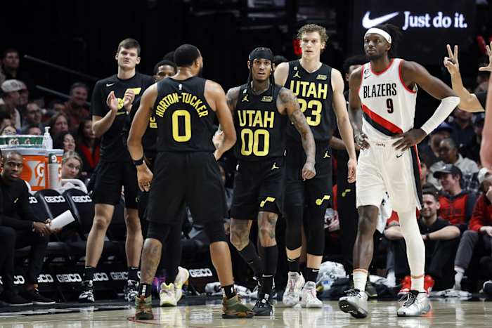 Utah Jazz point guard Jordan Clarkson (00) celebrates a basket and a foul with teammate Talen Horton-Tucker (0) during the second half against the Portland Trail Blazers at Moda Center.